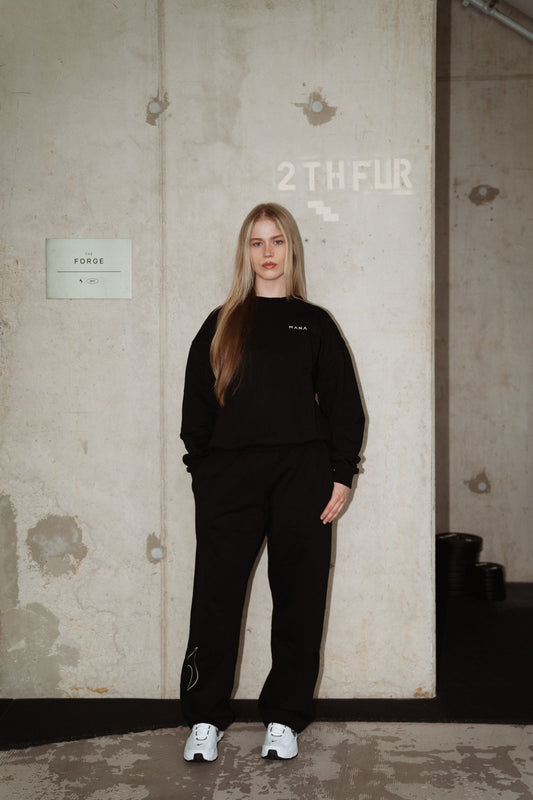 MANA SPC track pants in black, front
