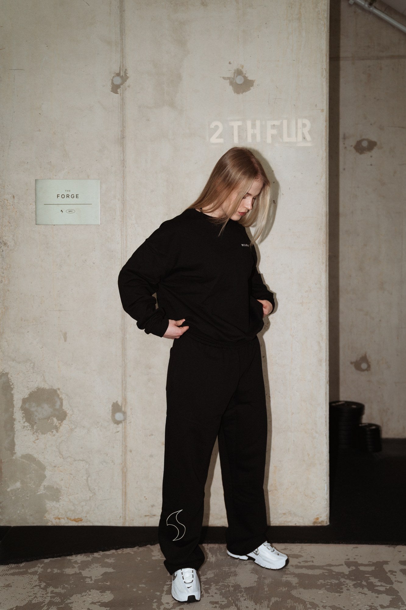 MANA SPC track pants in black, back