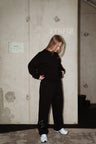 MANA SPC track pants in black, back