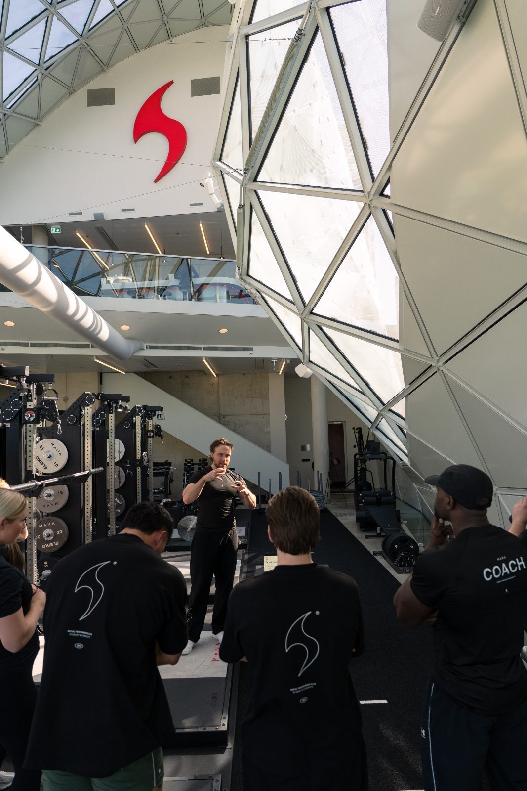 MANA coach briefing a corporate team under the glass dome of The Blob